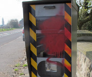 French speed camera spraypainted red